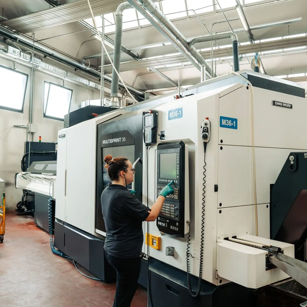 Precision CNC machining services operator at multi-spindle lathe