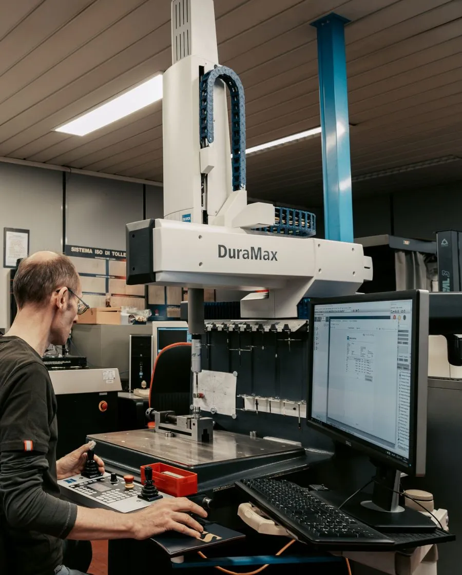 Operator performing dimensional inspection of turned metal parts